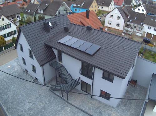 an overhead view of a white house with a roof at Rhein Appartements in Rheinhausen