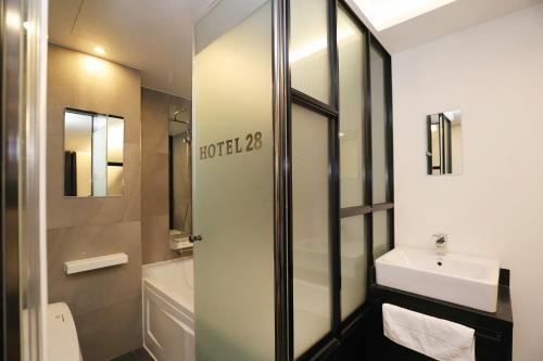 a bathroom with a shower and a sink and a toilet at Wolgot Unique Hotel 28 in Siheung