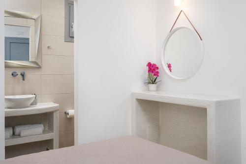 a white bathroom with a sink and a mirror at Bliss Holidays Spot in Fira