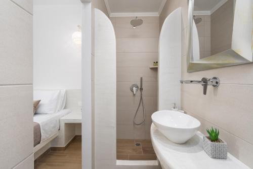a bathroom with a sink and a toilet in a room at Bliss Holidays Spot in Fira