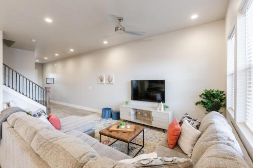 a living room with a large couch and a tv at Ocotillo 69 3 Bedrooms with a Private Hot Tub, Fire Pit, and Private Patio in Santa Clara
