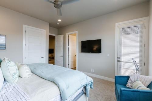 a bedroom with a bed and a blue couch at Ocotillo 69 3 Bedrooms with a Private Hot Tub, Fire Pit, and Private Patio in Santa Clara