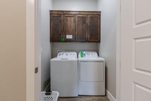 a laundry room with a refrigerator and a washer and dryer at Ocotillo 69 3 Bedrooms with a Private Hot Tub, Fire Pit, and Private Patio in Santa Clara