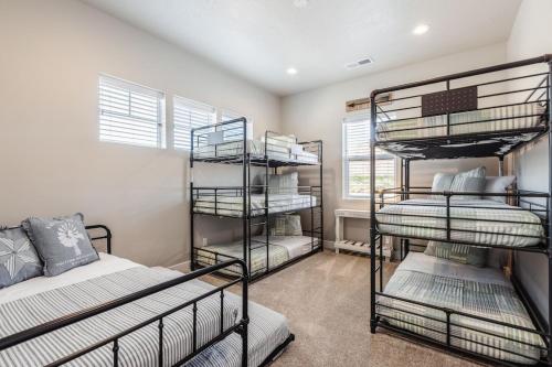 a room with three bunk beds and a bed at Ocotillo 70 Red Mountain View Resort, Private Pool & Hot Tub in Santa Clara