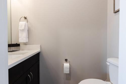 a white bathroom with a toilet and a sink at Ocotillo 70 Red Mountain View Resort, Private Pool & Hot Tub in Santa Clara