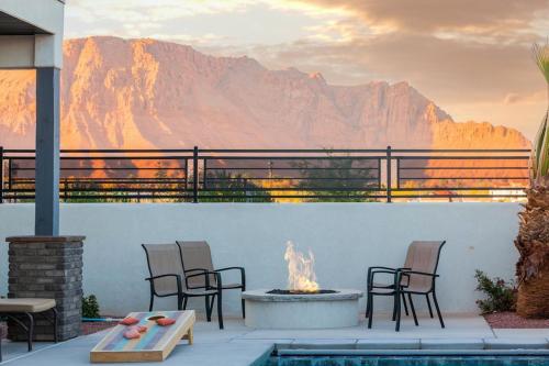 a patio with chairs and a fire pit with a mountain at Ocotillo 70 Red Mountain View Resort, Private Pool & Hot Tub in Santa Clara