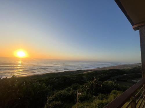 a sunset from the balcony of a house at Beach Escape on the coast at apartment 78 Sancta Maria in Amanzimtoti