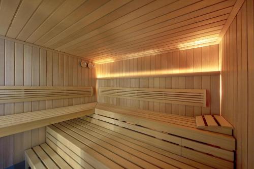 a wooden sauna with a bench in it at Castillo Hotel Son Vida, a Luxury Collection Hotel, Mallorca in Palma de Mallorca