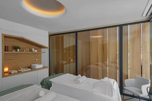 a hotel room with two beds and a chair at Castillo Hotel Son Vida, a Luxury Collection Hotel, Mallorca in Palma de Mallorca