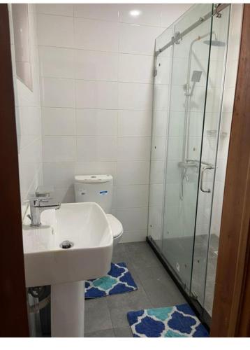 a bathroom with a toilet and a sink and a shower at American mall in Accra