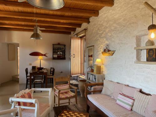 a living room with a couch and a table at Villa LA FAMILIA maison traditionnelle in Plakias