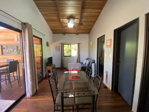 a living room with a glass table and chairs at CASA NATURaL in Brasilito