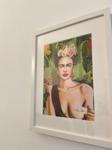 a painting of a woman holding a cup of coffee at Casa Mina Cadiz in Cádiz