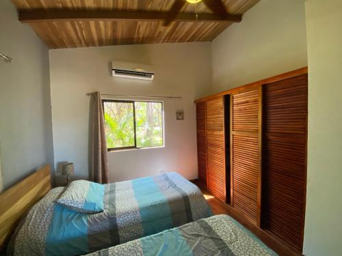 a bedroom with a bed and a window at CASA NATURAL in Brasilito
