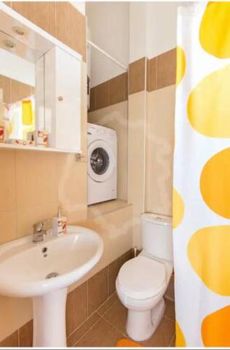 a bathroom with a sink toilet and a washing machine at Villa Armonia in Skala Potamias