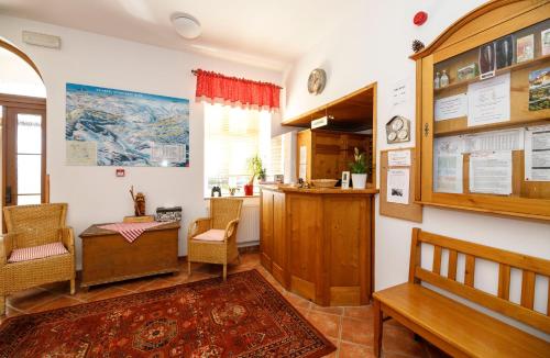 a room with a bench and a table and chairs at Svycarska Bouda in Špindlerův Mlýn