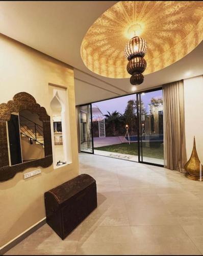 a large living room with a large ceiling at Villa Mattia piscine chauffée sans vis à vis in Marrakech
