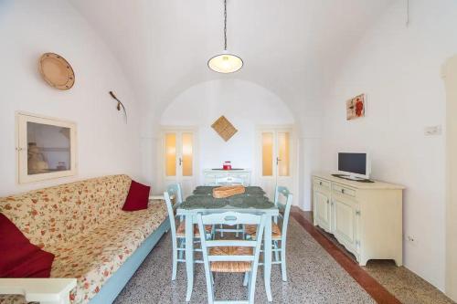 a living room with a table and a couch at Masseria Trulli sull'Aia in Cisternino