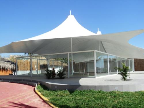 a large white tent in front of a building at Vichayito Bungalows & Carpas by Aranwa Hotels in Vichayito