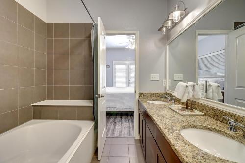 a bathroom with a tub and a sink and a bath tub at Barefoot Retreat MC15 in Port Aransas