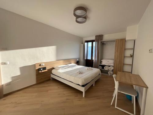 a bedroom with a bed and a desk in it at Residenza Sant'Angelo - Bike&Trekking House in Pietrapertosa