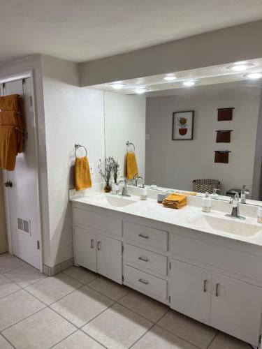 a bathroom with two sinks and a large mirror at The Airstream Lodge in Lubbock
