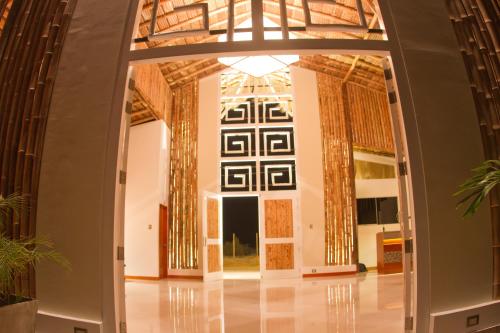 a hallway in a building with an open door at Vichayito Bungalows & Carpas by Aranwa Hotels in Vichayito