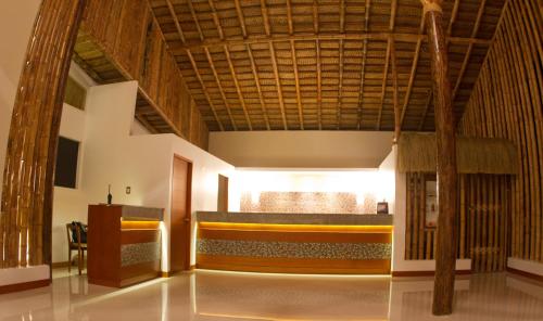 a large room with a wooden ceiling and a table at Vichayito Bungalows & Carpas by Aranwa Hotels in Vichayito