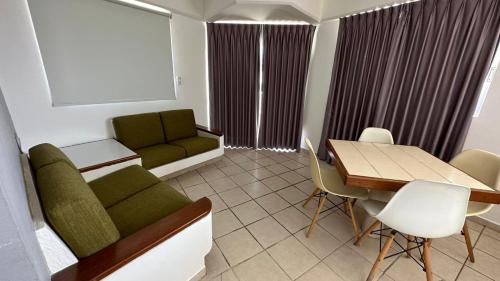 a living room with a couch and a table at Hotel Suites Regina in Veracruz