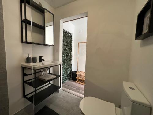 a bathroom with a white toilet and a sink at IN-Cascais Suite Deluxe com pátio privado in Cascais