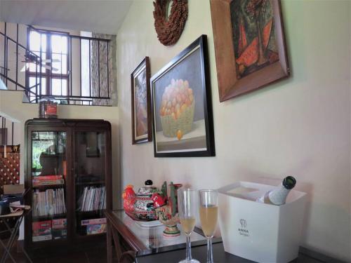a room with a table with wine glasses and pictures on the wall at Vista Gaital/ Gaital View in Antón