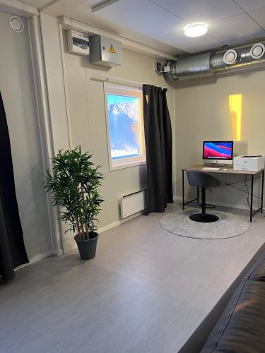 an office with a desk and a computer on a table at Kiruna City Room in Kiruna