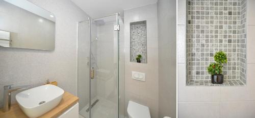 a bathroom with a shower and a toilet and a sink at Solaris Lux Apartments in Kotor