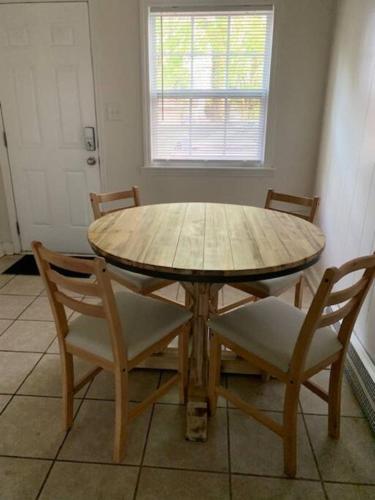 a wooden table and chairs in a room at Suite 6, Sleep 3, Walk to Attractions in Uptown in Charlotte