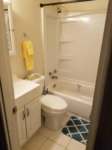 a white bathroom with a toilet and a sink at Suite 6, Sleep 3, Walk to Attractions in Uptown in Charlotte