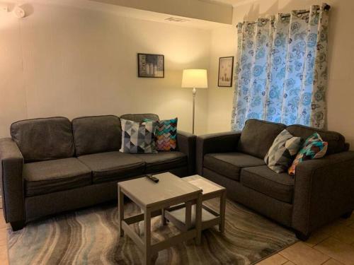 a living room with a couch and a table at Suite 6, Sleep 3, Walk to Attractions in Uptown in Charlotte