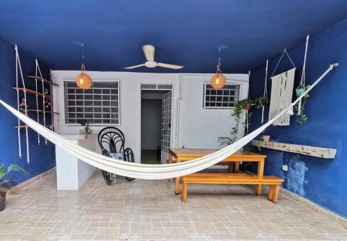 a hammock in a room with a blue wall at La 78 alberca y garage con porton electrico in Mérida