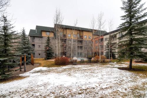 a large building with snow in front of it at Expedition Station Condos by Vail Resorts in Keystone