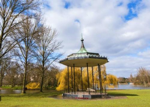 a gazebo in a park next to a lake at Victorian Building turned Charming Hotel Perfect For Short and Long Term Stay with WiFi in London