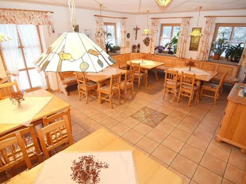 a dining room with wooden tables and chairs at Ferienhaus mit Wellnessbereich in Schönsee