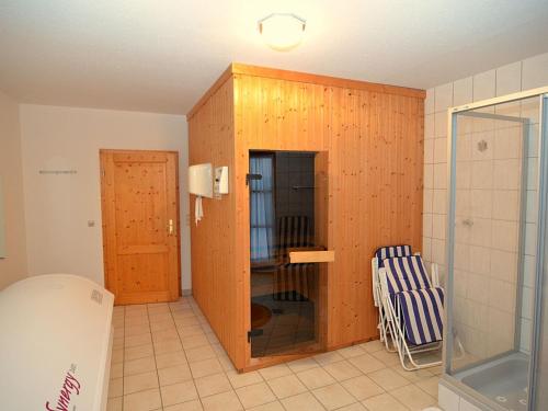 a room with a glass door and a chair in it at Ferienhaus mit Wellnessbereich in Schönsee