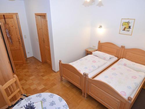 a small bedroom with two beds and a table at Ferienhaus mit Wellnessbereich in Schönsee