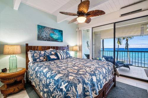 a bedroom with a bed with a view of the ocean at Oceanfront Luxury Condo in Kailua-Kona