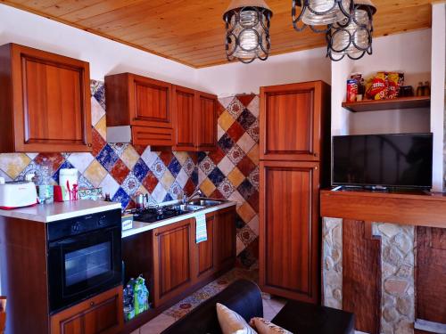 a kitchen with wooden cabinets and a tv in it at La Salira 