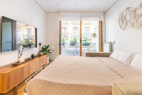 a bedroom with a large bed and a couch at Luxury Old TownGeneral Jauregi in San Sebastián