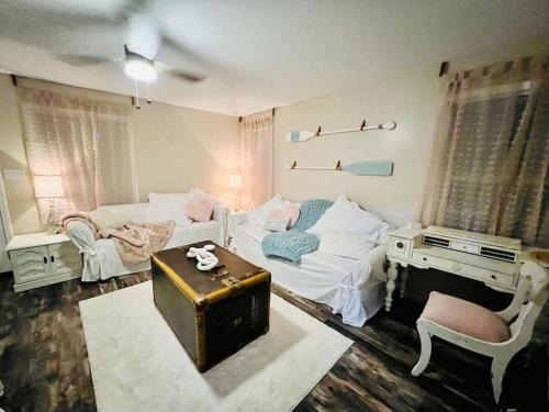 a room with a bed and a table and a couch at Coastal Casita by the River in New Bern