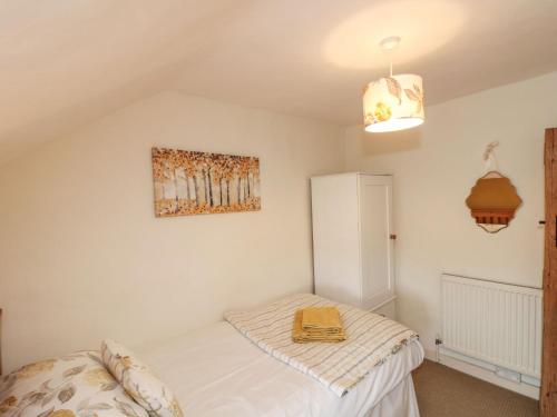 a bedroom with a bed and a picture on the wall at 12 Castlegate in Pickering
