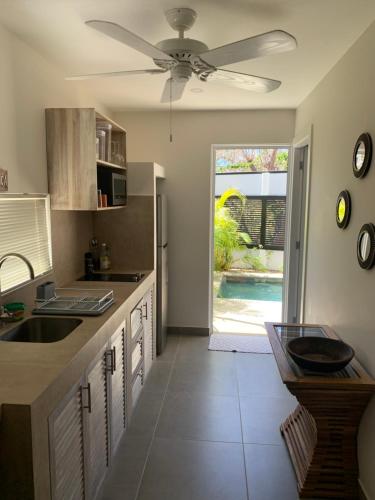 a kitchen with a ceiling fan and a sink at CASITA COCO in Playa Grande