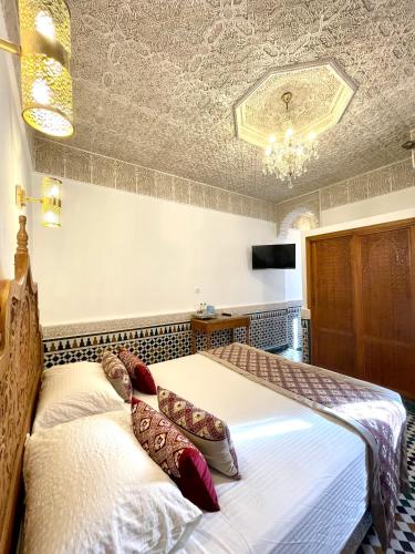 a bedroom with two beds with pillows on them at Le Grand Alcazar - Riad in Fès