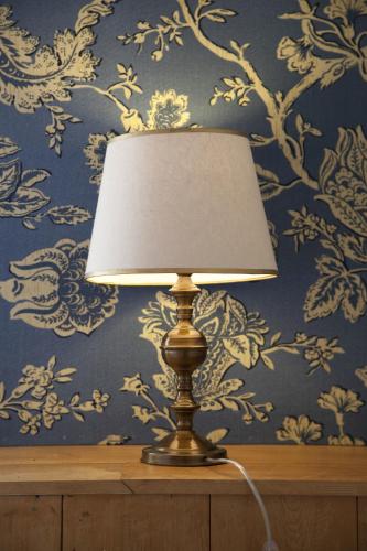 a lamp sitting on a table in front of a wall at Hotel Boutique Casa Werner in Puerto Varas